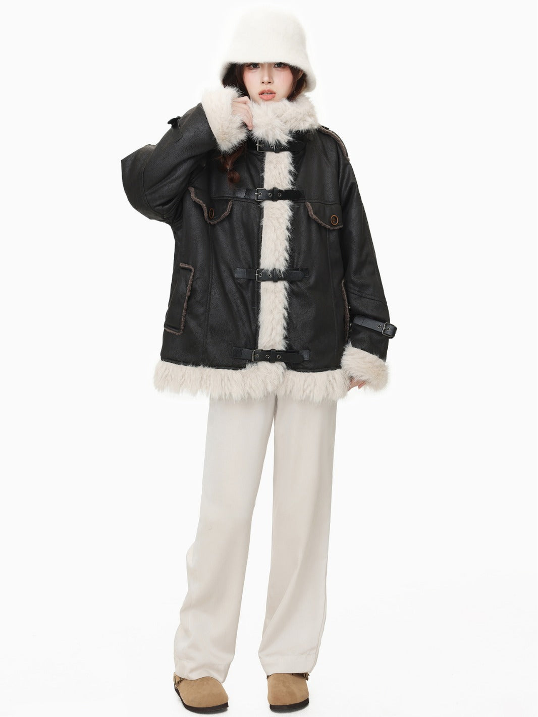 Model in black wool cotton blend Leather Coat with faux fur trim and relaxed fit, styled with winter accessories.