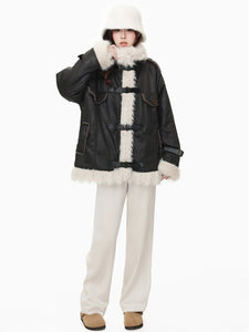 Model in black wool cotton blend Leather Coat with faux fur trim and relaxed fit, styled with winter accessories.