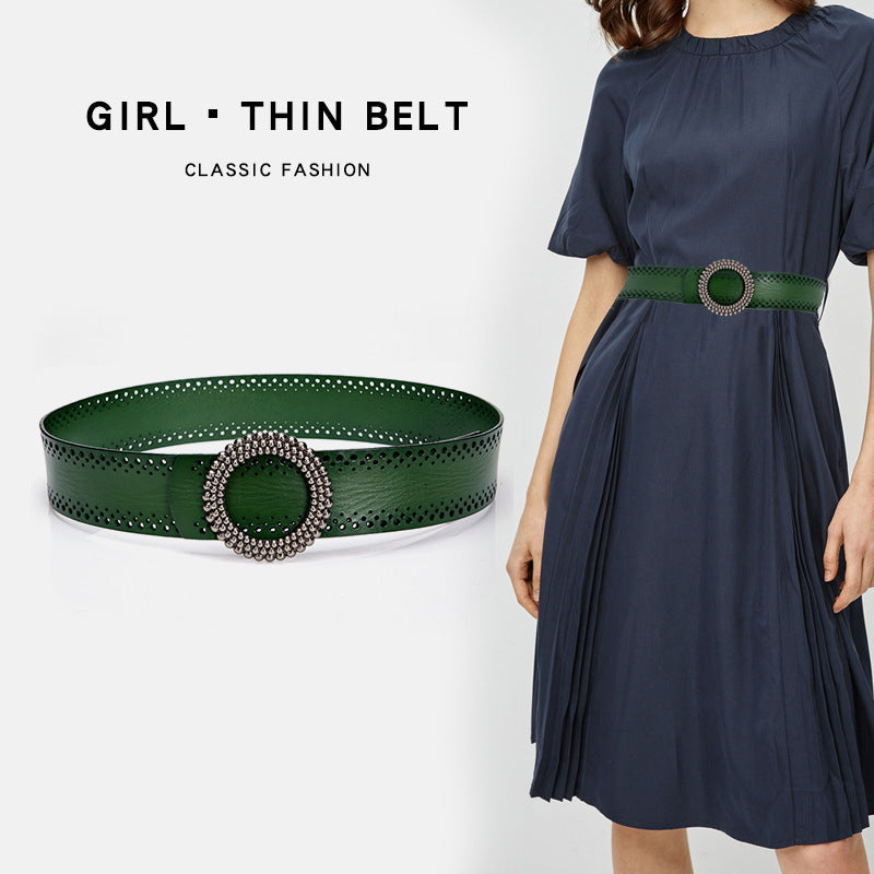 Women's belt no hole in green genuine leather with round beaded buckle, styled with navy dress for classic fashion look.