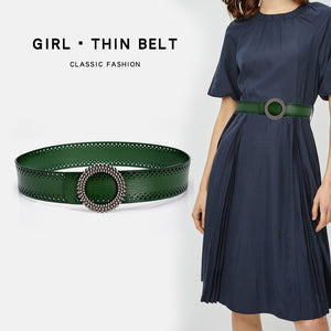 Women's belt no hole in green genuine leather with round beaded buckle, styled with navy dress for classic fashion look.